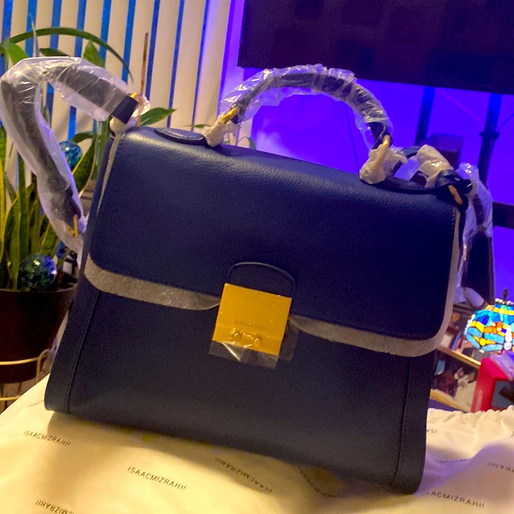 Never used bag. Cross body or hand strap.
